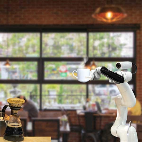 Robot pouring coffee into white mug