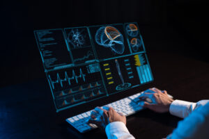 Man Sits In The Dark In Front Of A Virtual Menu. Close Up Of Male Hands On The Keyboard.