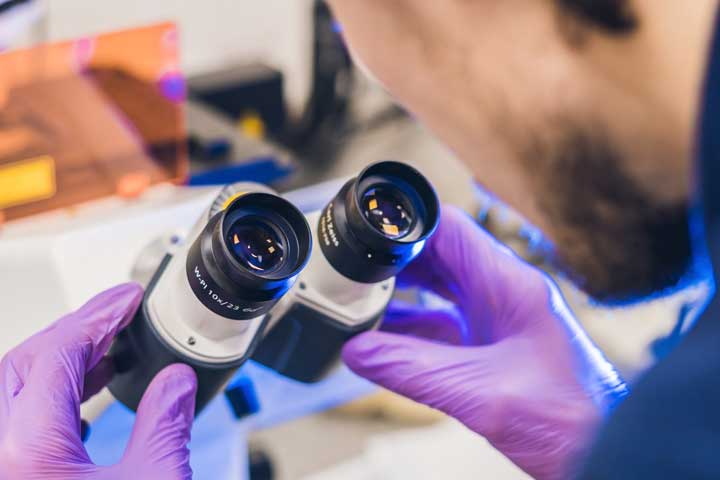 Scientist work on a confocal scanning microscope in a laboratory for biological samples investigation