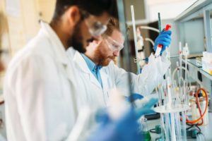 Two men in lab coats working in a science lab