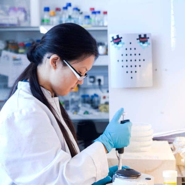 Female scientist pipetting specimens in laboratory